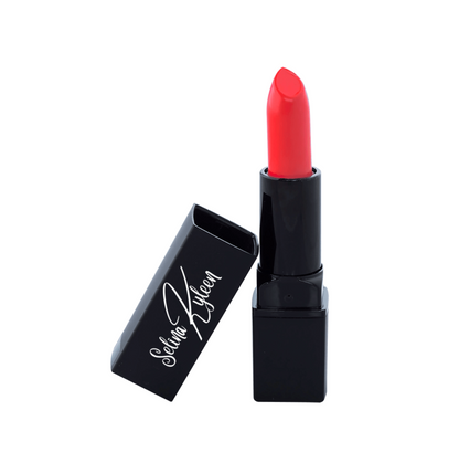 Red lipstick in black Selina Kileen case on white background